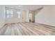 Bright and airy living room with large windows and wood-look vinyl floors at 27742 E 1St Ave, Aurora, CO 80018