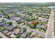 Wide aerial shot of neighborhood with lake and residential buildings and mountains in the background at 6671 Grove St, Denver, CO 80221