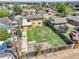 Backyard view showcases lawn with perimeter fence, along with adjacent homes and neighborhood at 6671 Grove St, Denver, CO 80221