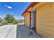 View of back porch featuring yellow siding and an exterior access door at 6671 Grove St, Denver, CO 80221