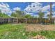 View of backyard featuring a wooden fence, some patchy grass, and exterior brick at 6671 Grove St, Denver, CO 80221
