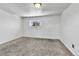 Cozy bedroom with neutral carpet, white walls, and a window offering natural light at 6671 Grove St, Denver, CO 80221