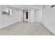 Bedroom featuring neutral carpet, white walls, sliding closet, and window with AC unit at 6671 Grove St, Denver, CO 80221