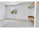 Bedroom with built-in shelving, window AC unit, and neutral carpeting, ready for personalization at 6671 Grove St, Denver, CO 80221