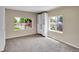 Cozy bedroom with carpet, two windows, and closet at 6671 Grove St, Denver, CO 80221