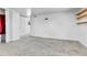 Bedroom featuring neutral carpet, white walls, a closet, and view into adjoining room at 6671 Grove St, Denver, CO 80221