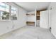 Bright bedroom with built-in closet space, a window AC unit, and neutral carpeting throughout at 6671 Grove St, Denver, CO 80221