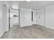 Bedroom with white walls, neutral carpet, storage closet, and exterior access door at 6671 Grove St, Denver, CO 80221