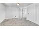 Bedroom featuring neutral carpet, white walls, and a storage closet with brass handles at 6671 Grove St, Denver, CO 80221