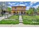 Inviting two-story home featuring a red roof, a star decoration, and a well-maintained front yard at 6671 Grove St, Denver, CO 80221