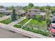 Two-story home with a front yard, featuring a fenced yard and a charming front porch at 6671 Grove St, Denver, CO 80221