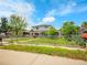Charming two-story home with a covered porch and a well-maintained lawn at 6671 Grove St, Denver, CO 80221
