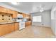 Inviting kitchen with wood cabinets, laminate countertops and backsplash, and a ceiling fan at 6671 Grove St, Denver, CO 80221