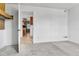 Spacious room with carpeted floors and a view into the kitchen, creating an open layout at 6671 Grove St, Denver, CO 80221
