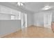 Open living space with neutral tile floors, white walls, and a pass-through to an adjacent room at 6671 Grove St, Denver, CO 80221