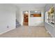 Bright living room with tile floors, stairs, and an opening to the kitchen with oak cabinets at 6671 Grove St, Denver, CO 80221