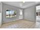 Open living room with tile floors, a large window, and a white front door at 6671 Grove St, Denver, CO 80221