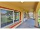 Inviting covered front porch with decorative columns, exterior lighting, and a bench at 6671 Grove St, Denver, CO 80221