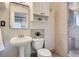 Bathroom featuring tiled shower, toilet, mirror, and floating sink at 2562 N Emerson St, Denver, CO 80205