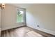 Empty bedroom with hard wood floors and a window at 2562 N Emerson St, Denver, CO 80205