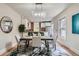 Chic dining room featuring a modern chandelier, seating for four, and a view to the kitchen area at 2562 N Emerson St, Denver, CO 80205