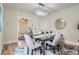 Open dining area with modern chandelier, a view to the living room, and light wood floors at 2562 N Emerson St, Denver, CO 80205