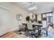 Elegant dining room with modern chandelier, seating for six, and view to the kitchen at 2562 N Emerson St, Denver, CO 80205