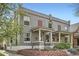 Attractive gray brick home with a covered front porch and a well-maintained brick landscape at 2562 N Emerson St, Denver, CO 80205