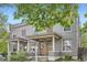 Inviting gray brick duplex featuring covered front porches, offering a blend of classic charm at 2562 N Emerson St, Denver, CO 80205