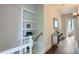 Upstairs hallway with storage shelves, light fixture, and access to bathroom at 2562 N Emerson St, Denver, CO 80205