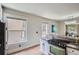 Kitchen featuring stainless appliances, white cabinets, granite counters, and eating space with chandelier at 2562 N Emerson St, Denver, CO 80205
