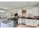 Well-lit kitchen features white cabinets, stainless appliances, tile backsplash, granite countertops and wine rack at 2562 N Emerson St, Denver, CO 80205