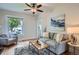 Cozy living room with hardwood floors, neutral decor, and a sunlit window for a bright, airy feel at 2562 N Emerson St, Denver, CO 80205