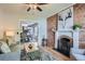 Inviting living room flows into dining area, featuring a brick accent wall and modern decor at 2562 N Emerson St, Denver, CO 80205
