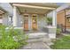 Charming porch with twin front doors and classic pillars, inviting entry to a well-maintained home at 2562 N Emerson St, Denver, CO 80205
