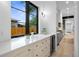 Stylish bar area featuring marble countertop, beverage fridge, modern fixtures, and natural light at 1126 S Garfield St, Denver, CO 80210