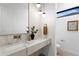 Chic powder room featuring a marble countertop, modern fixtures, and a sleek design at 1126 S Garfield St, Denver, CO 80210