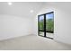 A room with neutral carpet and large window at 1126 S Garfield St, Denver, CO 80210