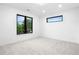 An empty bedroom with neutral carpet and large window at 1126 S Garfield St, Denver, CO 80210