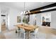 Bright dining room featuring a wooden table, chandelier, light wood floors, and eye-catching modern decor at 1126 S Garfield St, Denver, CO 80210