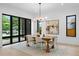 Well-lit dining area features a wood table, modern chandelier, large windows, and stylish decor at 1126 S Garfield St, Denver, CO 80210