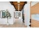 Bright foyer with light hardwood floors, a wood-paneled ceiling, and a glimpse into the adjacent rooms at 1126 S Garfield St, Denver, CO 80210