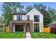 Modern two-story home with white siding, brick accents, and large windows, set on a green lawn at 1126 S Garfield St, Denver, CO 80210