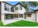 Contemporary home exterior featuring sleek black trim, large windows, a well-manicured lawn, and patio at 1126 S Garfield St, Denver, CO 80210