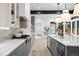Spacious kitchen with a long center island, marble countertops, modern appliances, and pendant lighting at 1126 S Garfield St, Denver, CO 80210