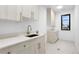 Light and bright laundry room featuring modern cabinetry and a window at 1126 S Garfield St, Denver, CO 80210
