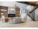 Modern living room featuring a fireplace, wood accent wall, and unique staircase at 1126 S Garfield St, Denver, CO 80210