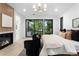 Serene main bedroom with fireplace and tree-filled backyard view at 1126 S Garfield St, Denver, CO 80210