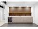 A close-up of the basement wet bar with wooden slats, modern countertop, wine refrigerator, and tile flooring at 1126 S Garfield St, Denver, CO 80210