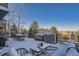 Covered patio with snow covered furniture and grill at 415 S Snowmass Cir, Superior, CO 80027